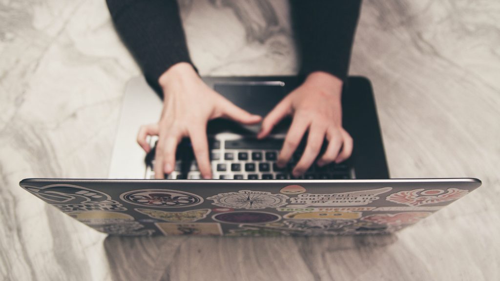 Supporting Image Person writing email on laptop