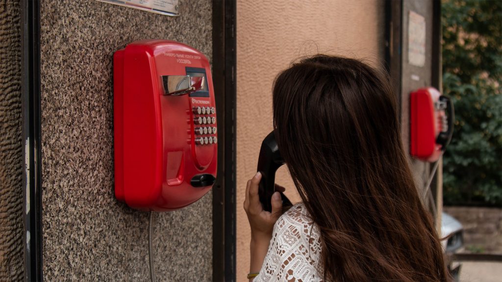 Elevate your business Woman using red telephone